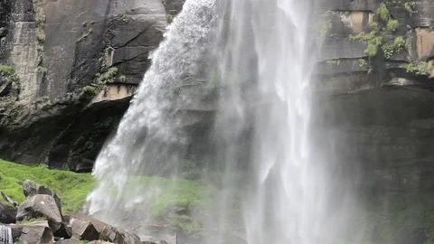 Waterfall over a grotto in a rock Stock Footage 95330960