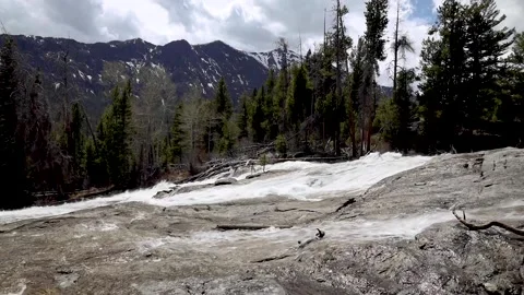 Waterfall over huge rocks in the mountains Stock Footage 155984536