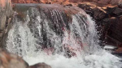 Waterfall Over Red rocks. Flowing Water Over Red Rocks Stock Footage 267136496