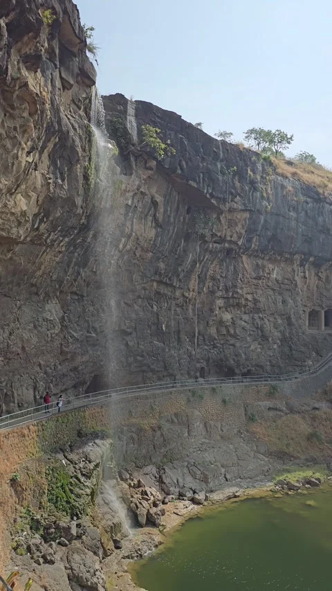 Waterfall over rock cliff pool, India Vertical 4K Video stock 348265533