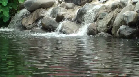 Waterfall Over The Rocks Into A Pond Stock Footage 33319554