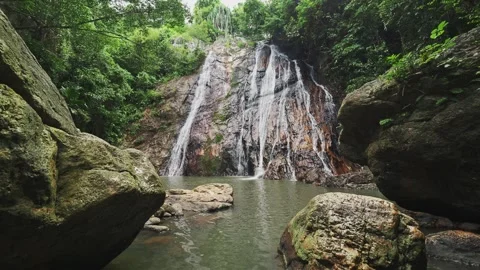 Waterfall over rocks in rainforest Stock Footage 331341928