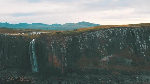 Waterfall over the steep cliffs decending into the ocean - Drone 4K 動画素材 113742080
