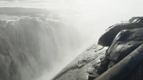 Waterfall overflowing rapidly producing mist Stock Footage 234908569