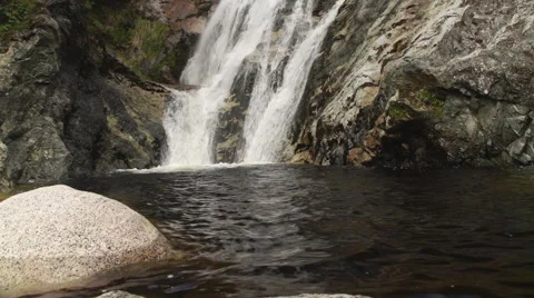 Waterfall, pan up from pond to top of falls. Stock Footage 49803465