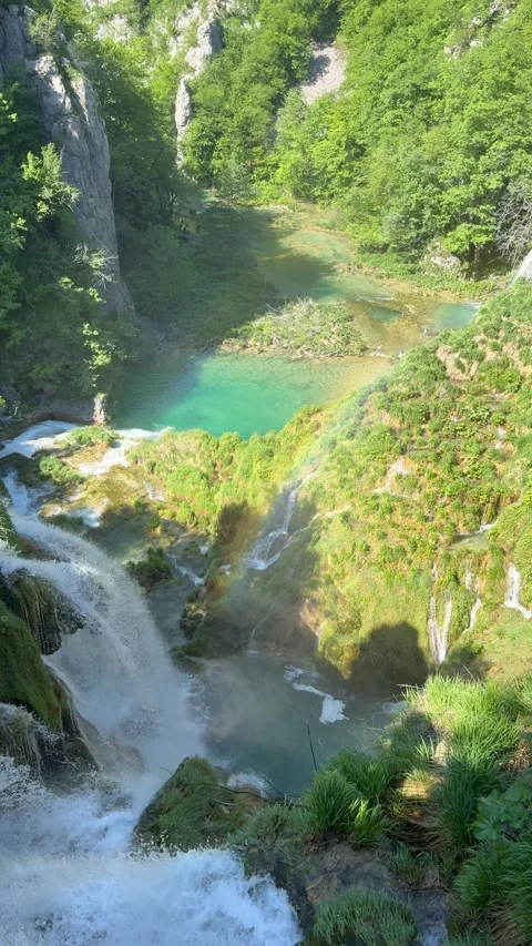 Waterfall at Plitvice Lakes with turquoise water and rainbow under sunlight. The Stock Footage 337356292