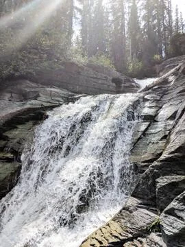 Waterfall pouring down rocks Stock Photos