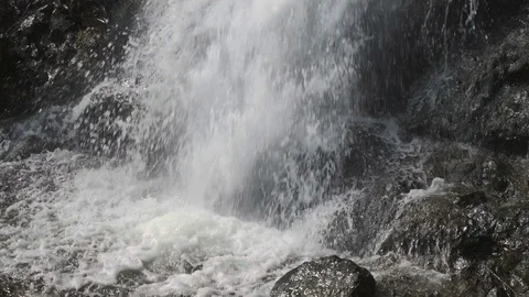 Waterfall pouring into rocks and creating natural little forest pond Stock Footage 109620653