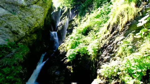 Waterfall produced by the rio arno in the mountain area of the gran sasso Stock Footage 136824198