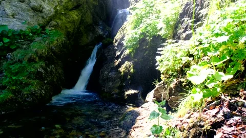 Waterfall produced by the rio arno in the mountain area of the gran sasso Video stock 136824237