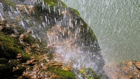 Waterfall rain falling on wet rock Stock Footage 124389785