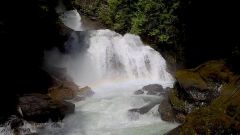 Waterfall, rainbow and moss covered rocks Stock Footage 110967416