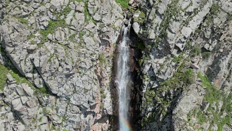 Waterfall with a rainbow in mountains. Cinematic drone flight in Ala-Archa Stock Footage 272480700