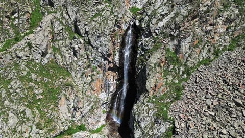 Waterfall with a rainbow in mountains. Cinematic drone flight in National Park Stock Footage 299778172