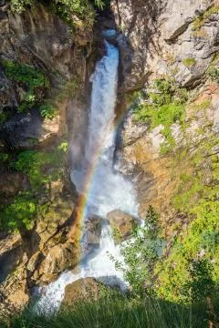 Waterfall with a rainbow. Stock Photos