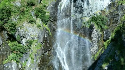 Waterfall with rainbow reflection in Fagaras Mountains , Romania Stock-Footage 286226726