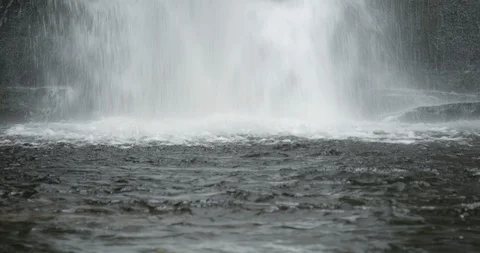 Waterfall rippling in pool at base Stock Footage 120432348