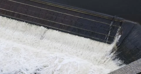 Waterfall river dam. City threshold structure with water foam falls down stream Stock Footage 296232466