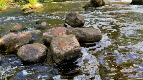 Waterfall from river. Mountain river with a waterfall and stones in lake. Vídeo Stock 218645650