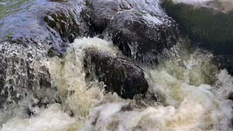 Waterfall from river. Mountain river with a waterfall and stones in lake. Stock Footage 218655108