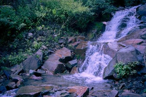 Waterfall in the river mountain with rocks. Stock Photos