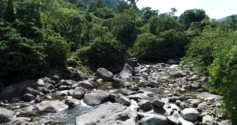 Waterfall river with rocky mountain flying movement by drone Stock Footage 133357385