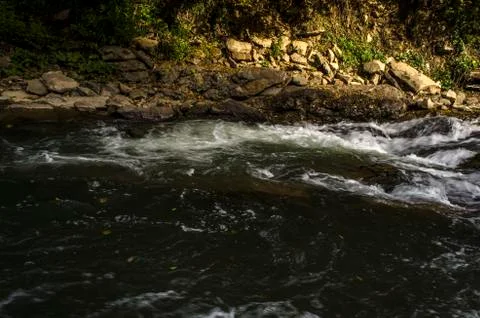 Waterfall on the river in the sun Stock Photos