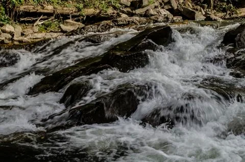 Waterfall on the river in the sun Stock Photos
