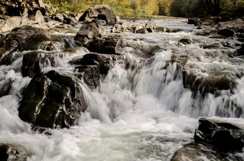 Waterfall on the river in the sun Stock Photos