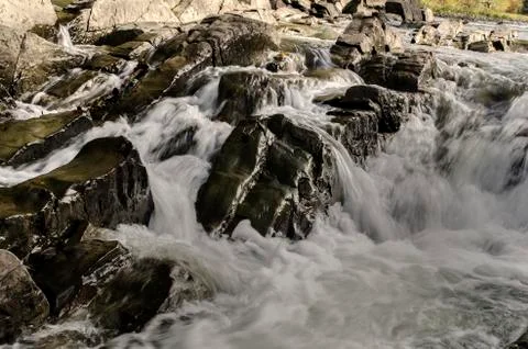 Waterfall on the river in the sun Stock Photos