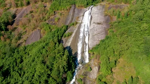 Waterfall on a rock in the mountain with trees Stock Footage 167404652