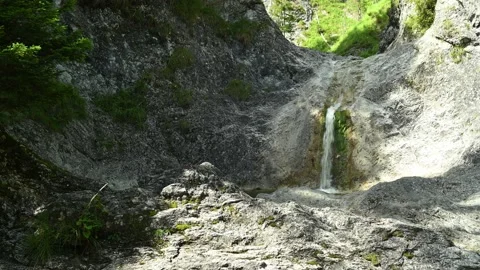 Waterfall with rocks and a natural pool in the Bavarian Alps Video stock 211743772