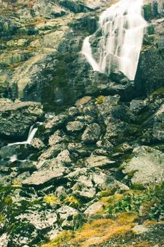 Waterfall in rocks. Fast mountain river Stock Photos
