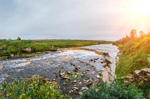 Waterfall rocks lowland river fields meadows Foto stock