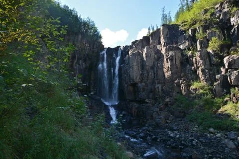 Waterfall in the rocks. Stock Photos