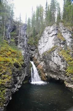 Waterfall in the rocks. Stock Photos