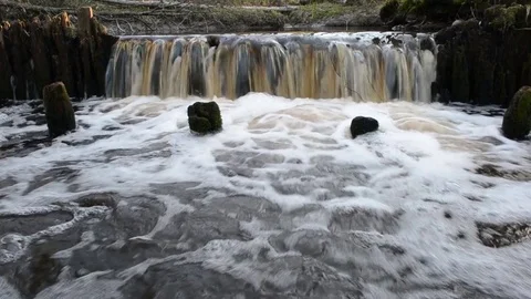 Waterfall on the ruins of an old mill Stock Footage 75978795