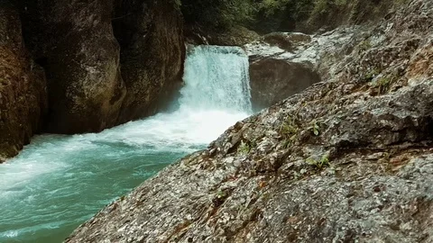 Waterfall running down cliffs in the forest. Video stock 123991329