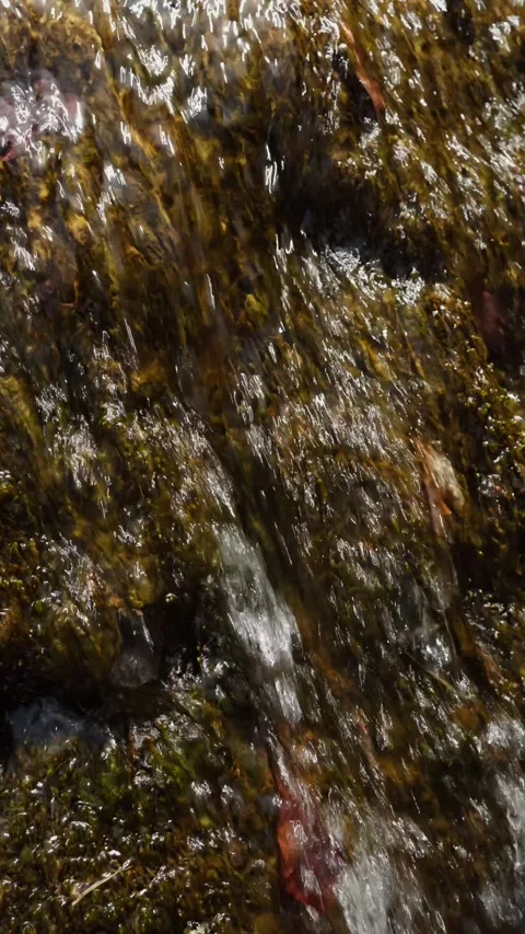 Waterfall rushes with vigorous motion through rocky landscape, displaying Stock Footage 311155397