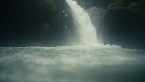 Waterfall rushing into a pool of water in a rainforest Jungle Stock Footage 282946202