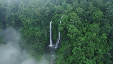 Waterfall seen through the clouds from above surrounded with fog and mist. Stock Footage 241403082