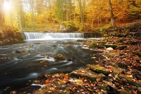 Waterfall with a shining sun Stock Photos