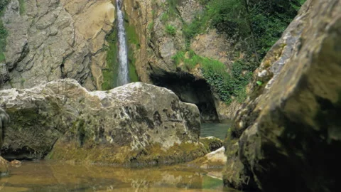 Waterfall in Slow motion. Mountain waterfall formed by spring streams. The Stock Footage 223339084