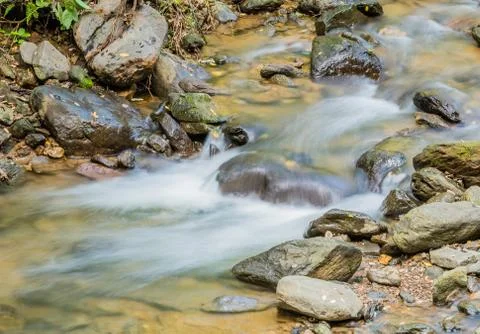 Waterfall in small mountain stream. Stock Photos