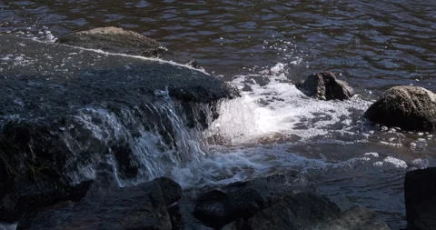 Waterfall in small stream, water splashing onto rocks. Close up. 스톡 동영상 157869302