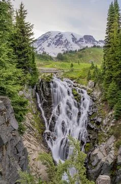 Waterfall with snow-capped Mount Rainier in background Stockfoto's