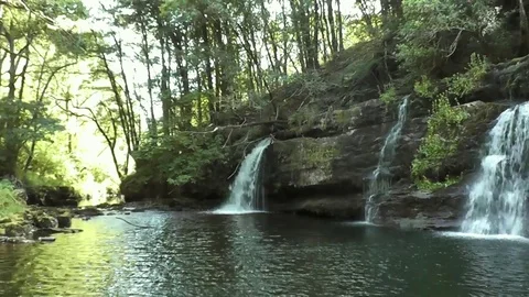 Waterfall spilling into tranquil pool (Sgwd y Pannwr, Wales) Stock Footage 92576152