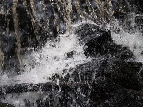Waterfall splash over the rocks, closeup Stock Photos