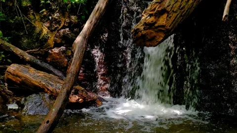 Waterfall splash, spring water as it falls and dribbles on rocks covered Stock Footage 124807726
