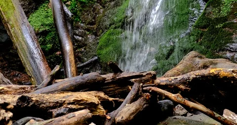 Waterfall splash, spring water as it falls and dribbles on rocks covered Stock Footage 125773285